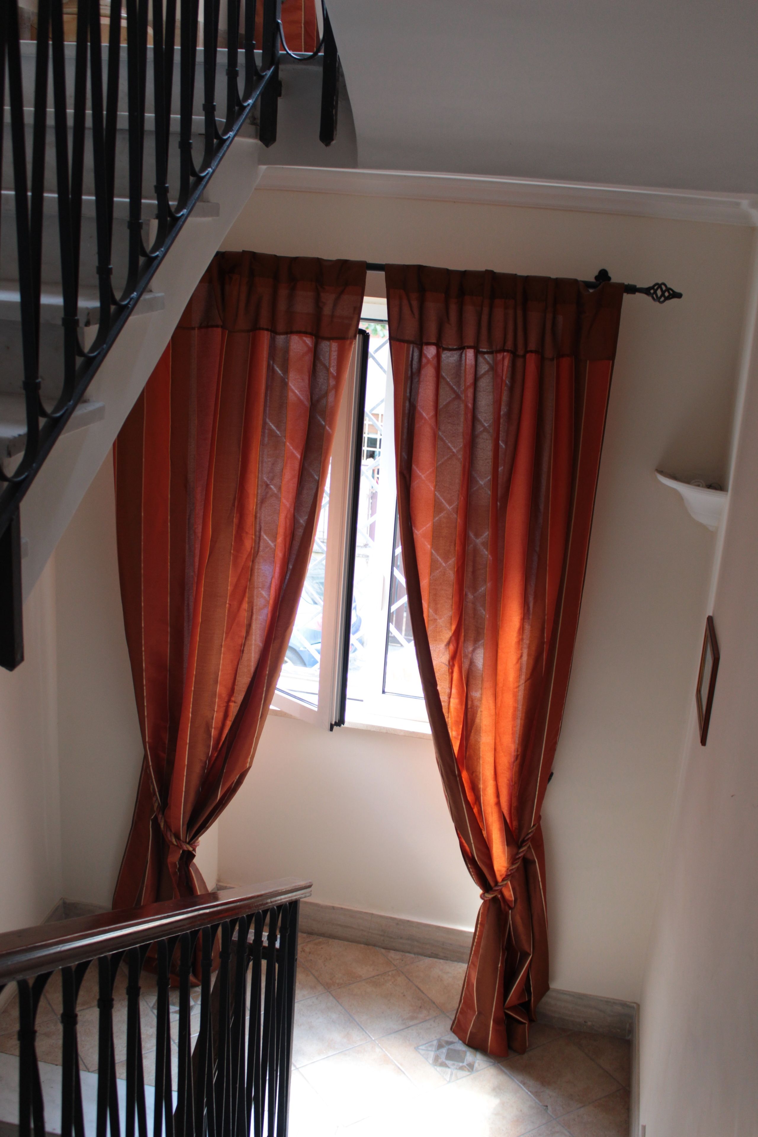 A staircase with a black railing leading to an upper floor.
