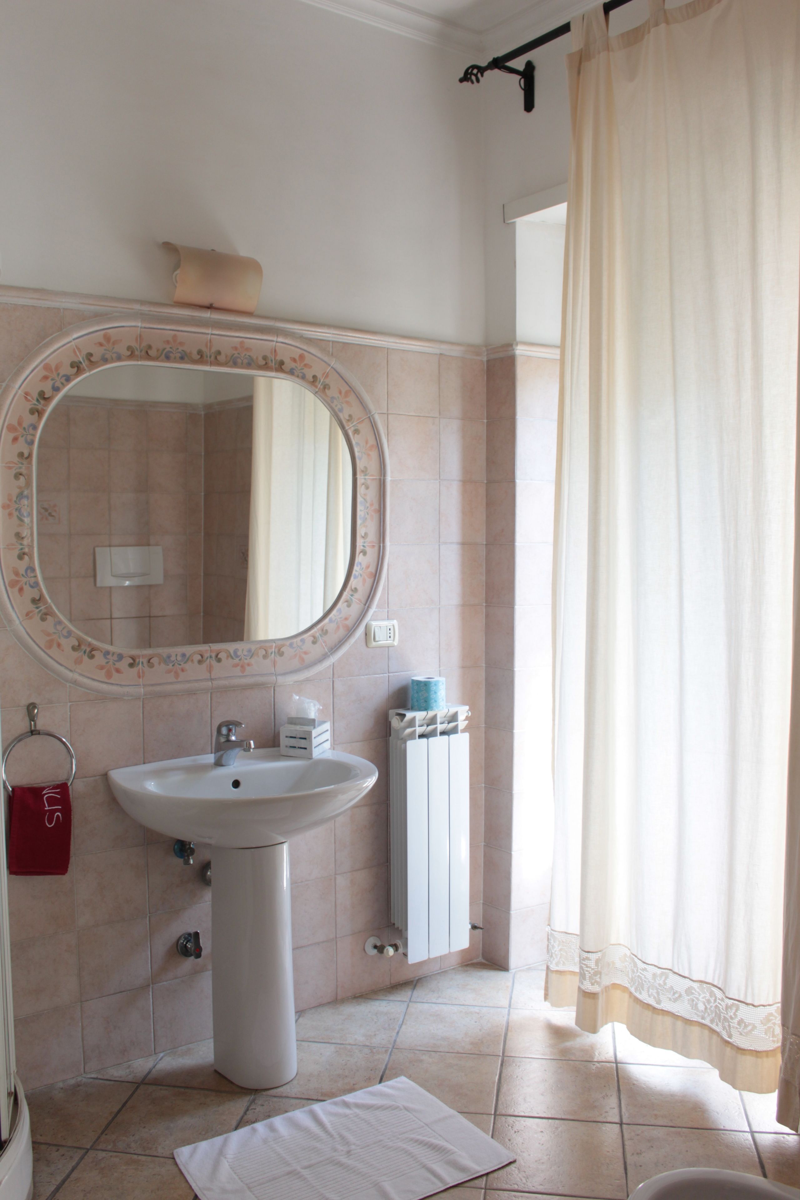 A bathroom with a sink, mirror, and toilet.