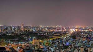 A densely packed urban area with numerous buildings and streets at night. - Saigon City View Apartment & Pool (Ho Chi Minh City)