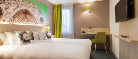A hotel room with a large bed, a desk, a chair, a television, and a decorative wall piece.