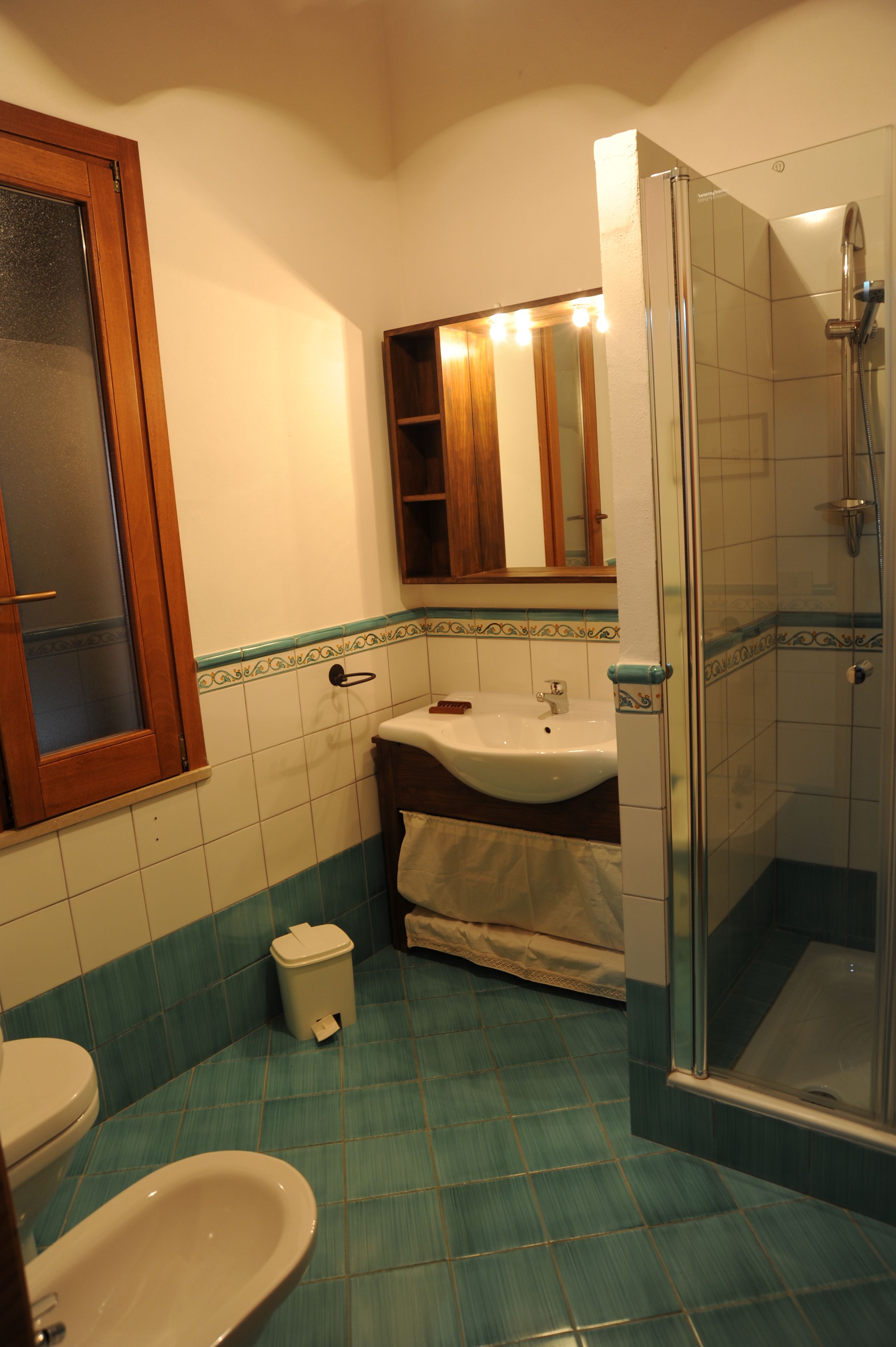 A bathroom with a toilet, sink, and shower.