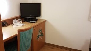 A small room with a wooden desk, a chair, a television, and a cabinet. - Gasthaus Lamm (Pforzheim)