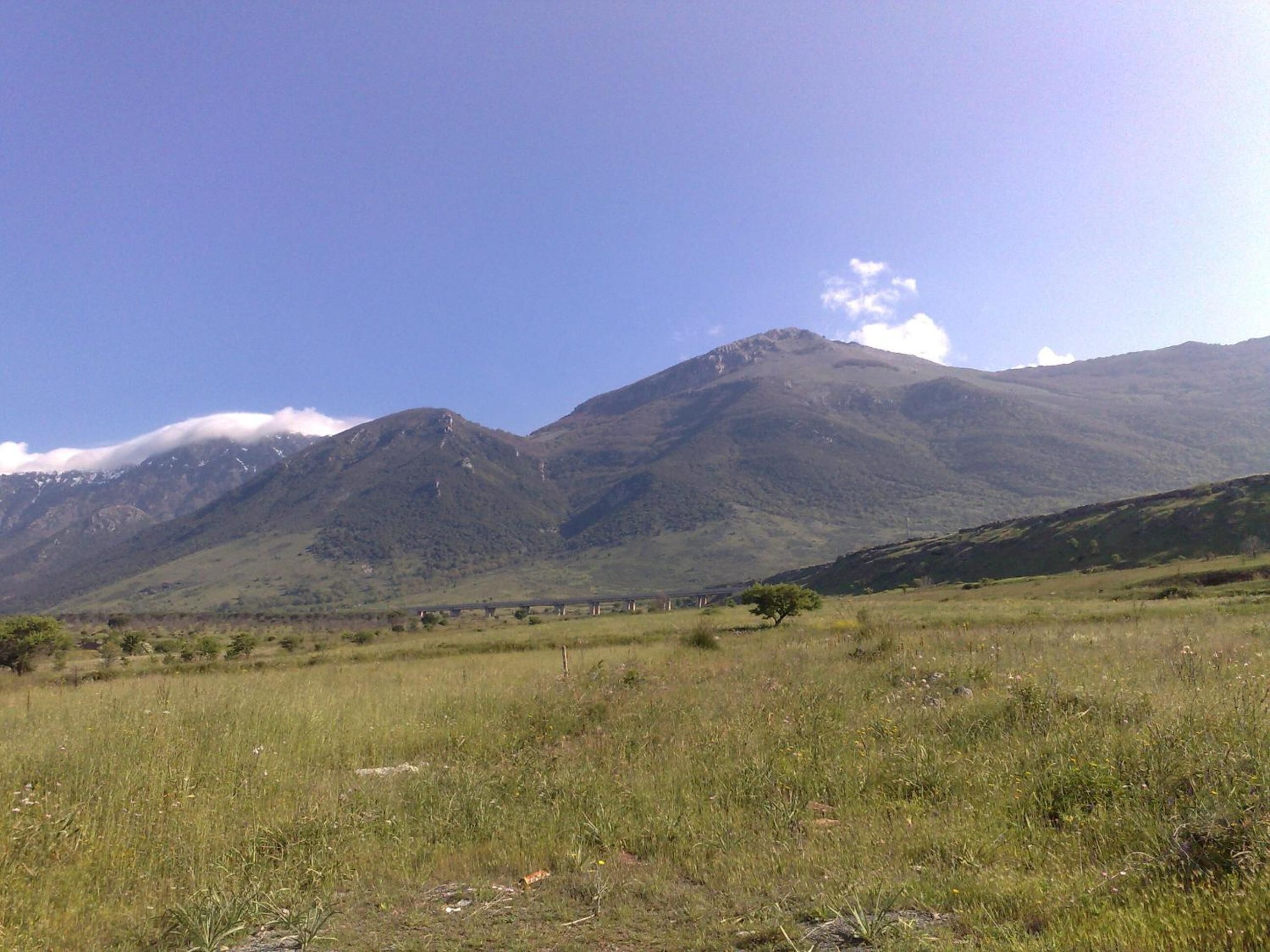 A mountainous landscape with a clear sky.