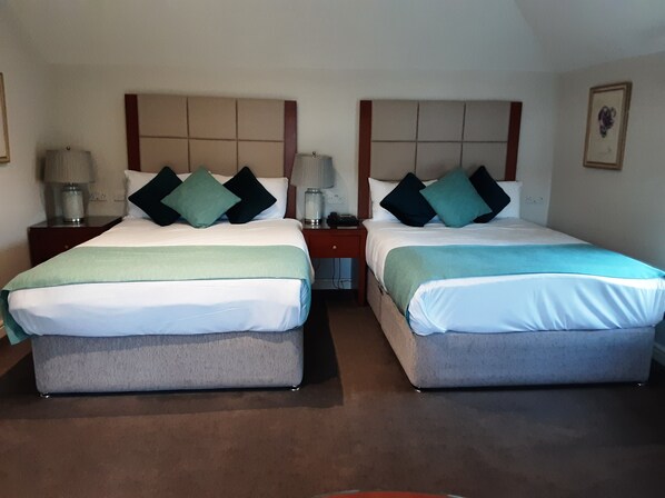 Two twin beds with headboards, bedside tables with lamps, and a framed picture on the wall. - Leixlip Manor Hotel (Leixlip)