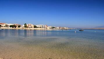 On the beach, sun-loungers
