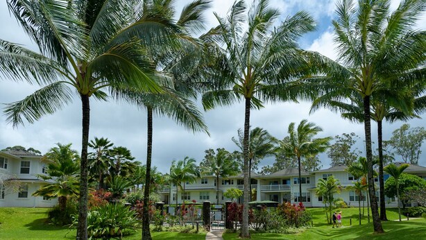 A resort with multiple-story buildings, a well-maintained lawn, and several palm trees. - 3br Plantation at Princeville! AC, fitness center, hot tub,, garage, more! (Princeville)