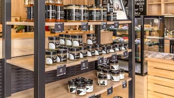 Shelves stocked with jars of food products, each labeled with prices.