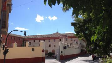 A building with a sign reading "HOSPEDERIA Nuestra Señora del Carmen" and a gated entrance.