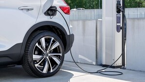 A white electric vehicle charging at a station. - Ruyge Weyde Logies (Oudewater)