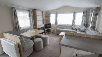 Two Bedroom Caravan | Living area | 22-inch TV with cable channels
