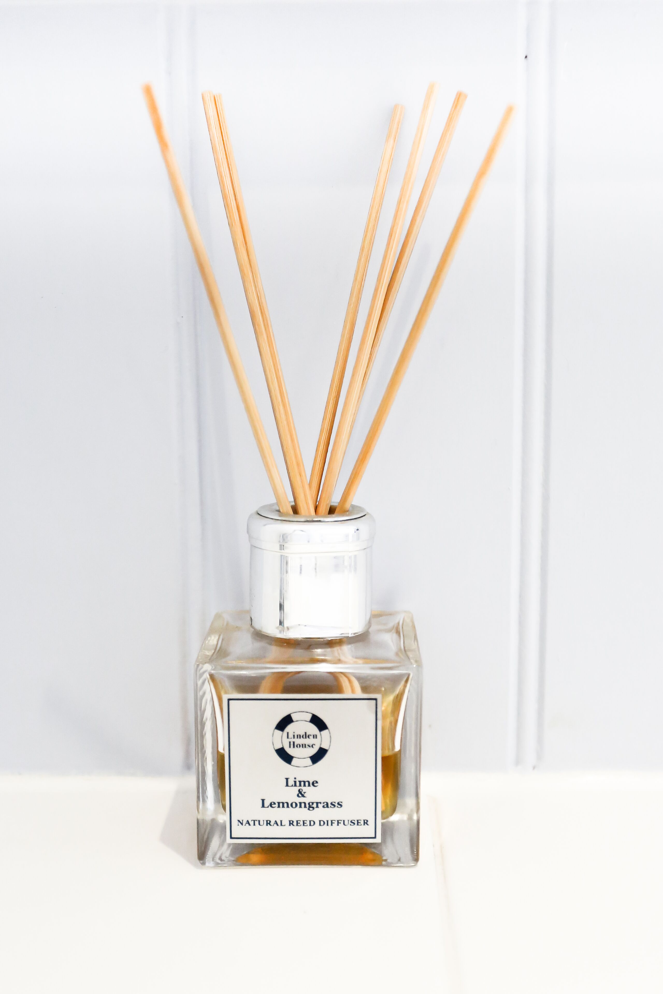 A bottle of Linden House Lime & Lemongrass natural reed diffuser.
