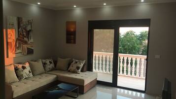 Deluxe Apartment, 1 Bedroom, Sea View | Living room | TV