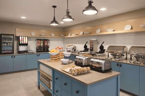 A breakfast bar with a toaster, coffee maker, and various food items. - Country Inn & Suites by Radisson, Ft. Atkinson, WI (Fort Atkinson)