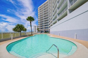 A swimming pool with a clear blue water surface, surrounded by a white building with balconies. - LIGHTHOUSE! Popular Property! ~ 1 BR Beach Front! XTRA BATH! (Gulf Shores)