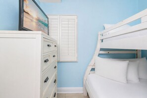 A bedroom with a bunk bed, a dresser with drawers, and a window with shutters. - LIGHTHOUSE! Popular Property! ~ 1 BR Beach Front! XTRA BATH! (Gulf Shores)