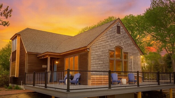 A wooden cabin with a deck, large windows, and a covered outdoor seating area. - Sun, Sand, and Serenity: Only 3 peak weeks remaining - Includes Private Beach (Eastham)