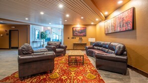 A lobby with leather sofas, a patterned rug, a painting, and a wooden ceiling. - The best view in Center Village.  Perfect for Concerts and Skier watching!!! (Copper Mountain)