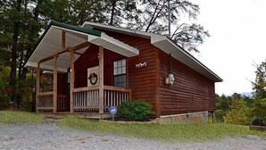 A wooden cabin with a porch, a sign indicating 'No Parking', and a wreath on the door. - Gatlinburg Cabin, Free Tickets, Secluded Mtn Views, Hot Tub, Heart Tub, Internet (Gatlinburg)