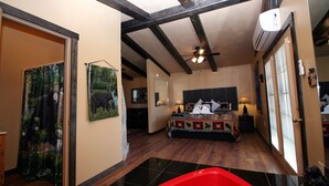 A bedroom with a bed, a ceiling fan, and a window. - Gatlinburg Cabin, Free Tickets, Secluded Mtn Views, Hot Tub, Heart Tub, Internet (Gatlinburg)