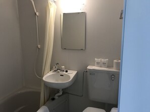 A bathroom with a white sink, a mirror, and a toilet. - Fuji Sansuikan (Fujikawaguchiko)