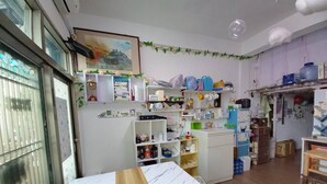 A compact kitchen with white cabinets, a marble countertop, and various kitchen appliances. - XIAN BnB (Jinhu)