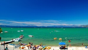 A beach with boats, people, and a rental area. - Basque Haus at Northstar:Beautiful A-Frame Minutes to Golf, Mtn Biking and Tahoe (Truckee)