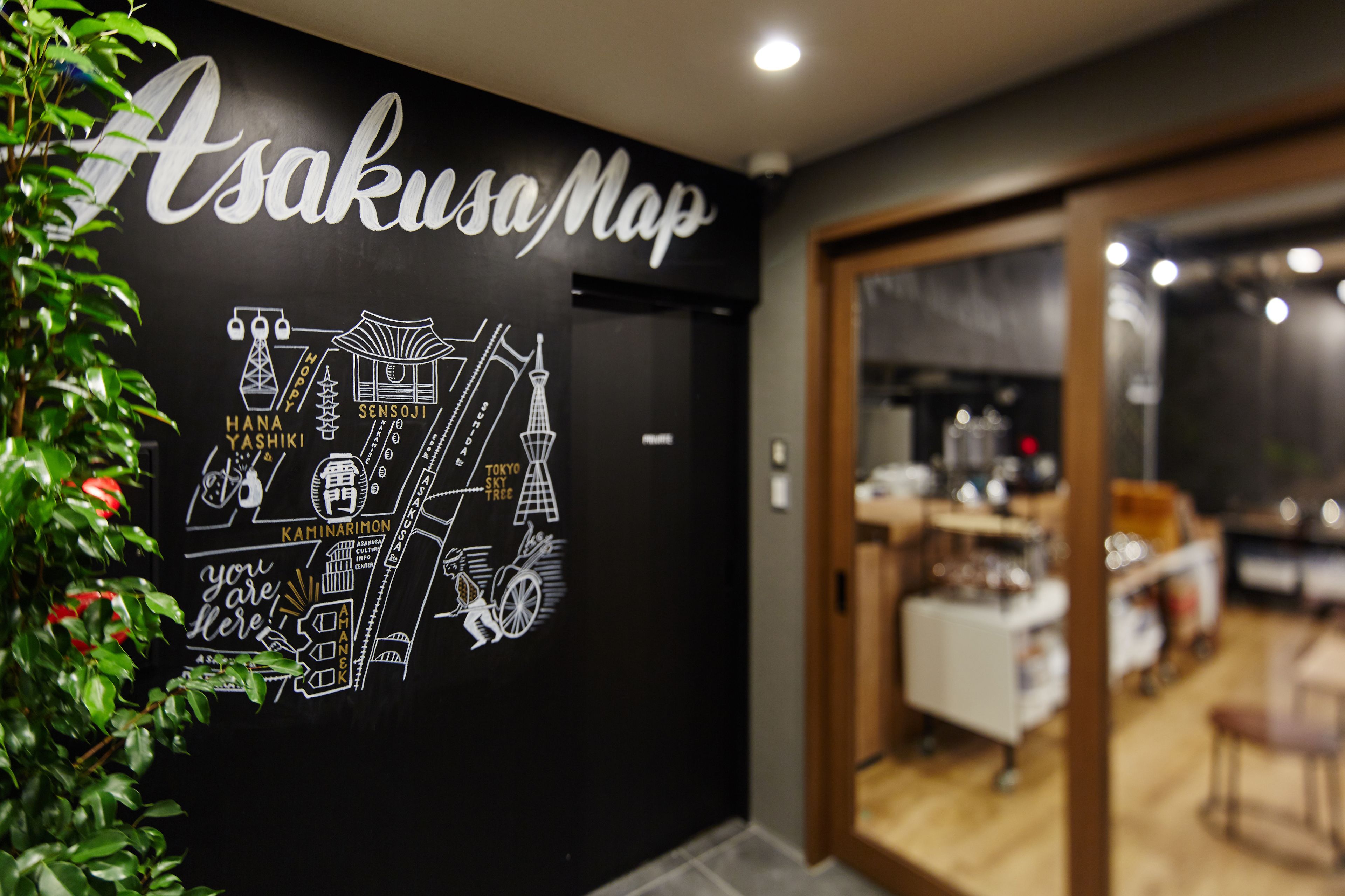 A wall with a map of Asakusa, Tokyo, highlighting landmarks like Hama Yashiki and Tokyo Skytree.