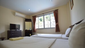 A hotel room with two beds, a TV, a dresser, and an air conditioning unit. - Sleep Inn Hotel (Krabi)