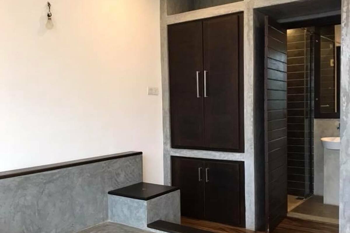 A bedroom with a bed, wardrobe, and a bathroom.