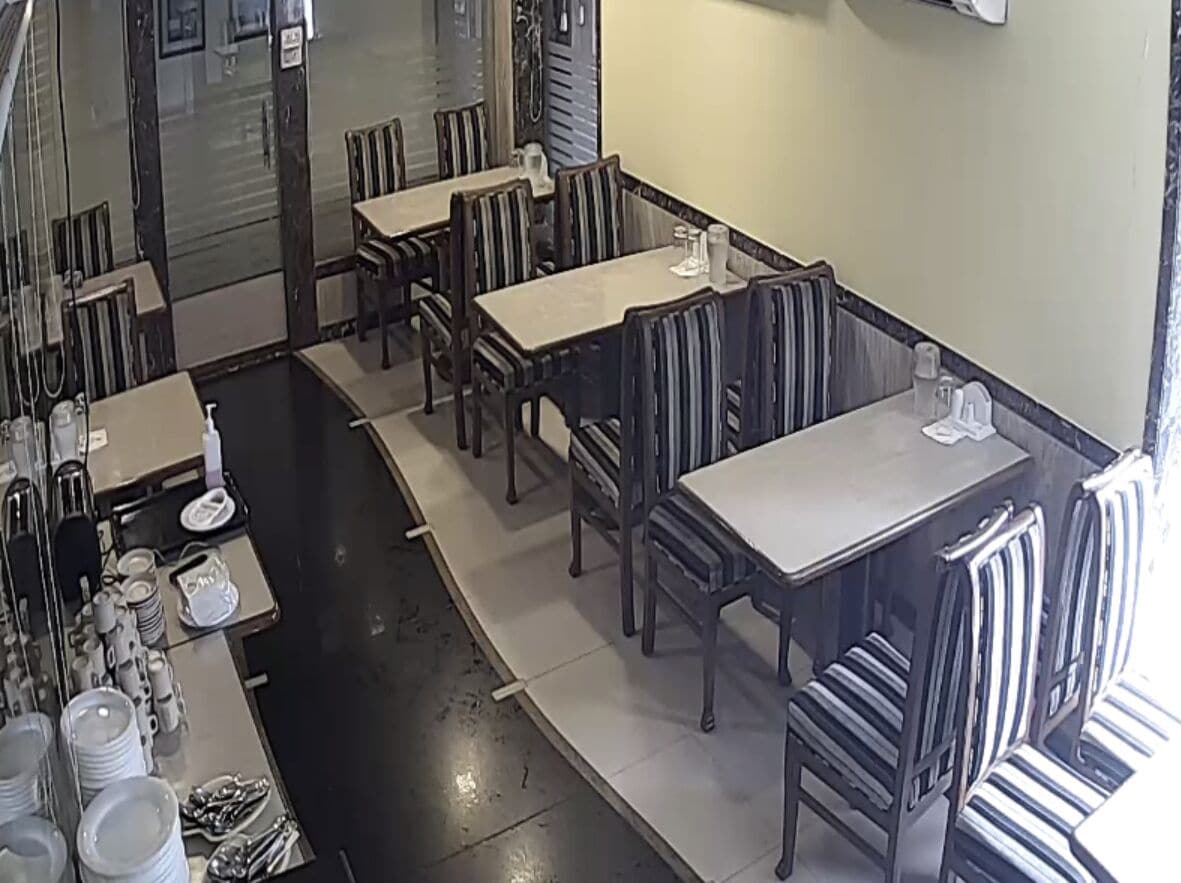 A restaurant with multiple dining tables and booths, arranged in a spacious layout.
