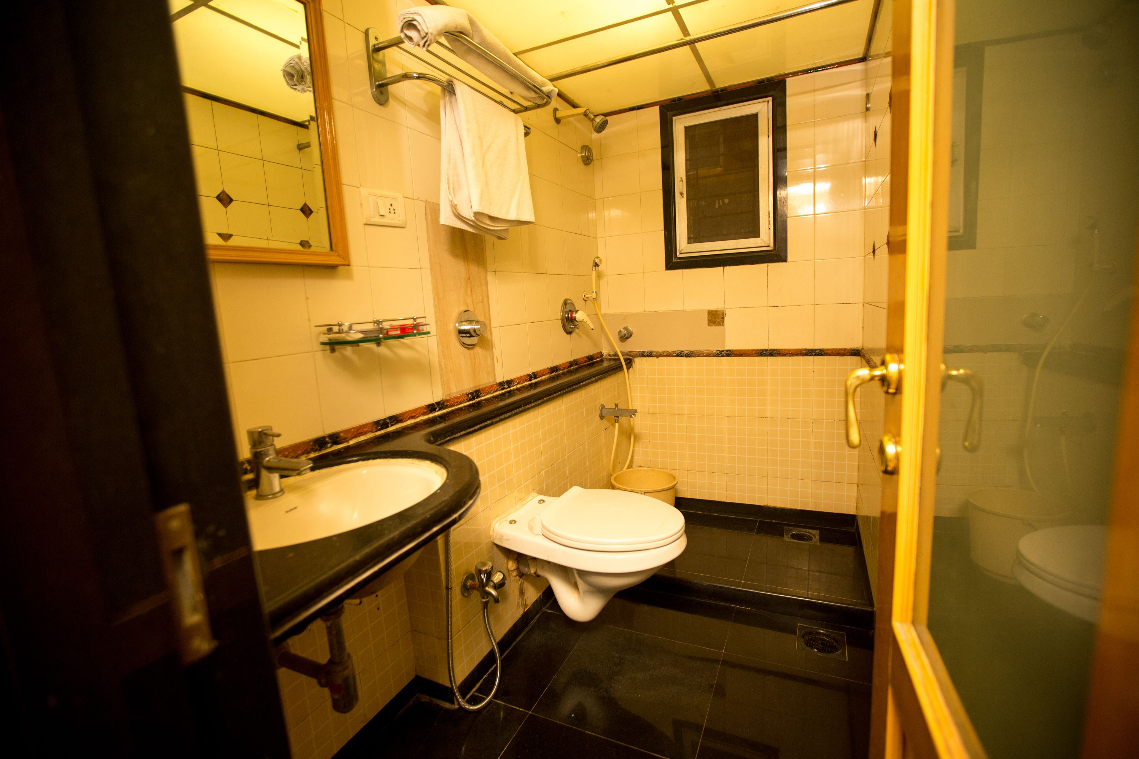 A bathroom with a toilet, sink, and shower.