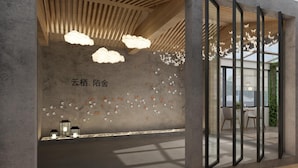 A modern interior with a concrete wall, wooden ceiling, and a glass partition. - Suzhou Cloud Art Inn (Suzhou)