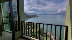 Ein Balkon mit Blick auf einen stillen See und ferne Berge.