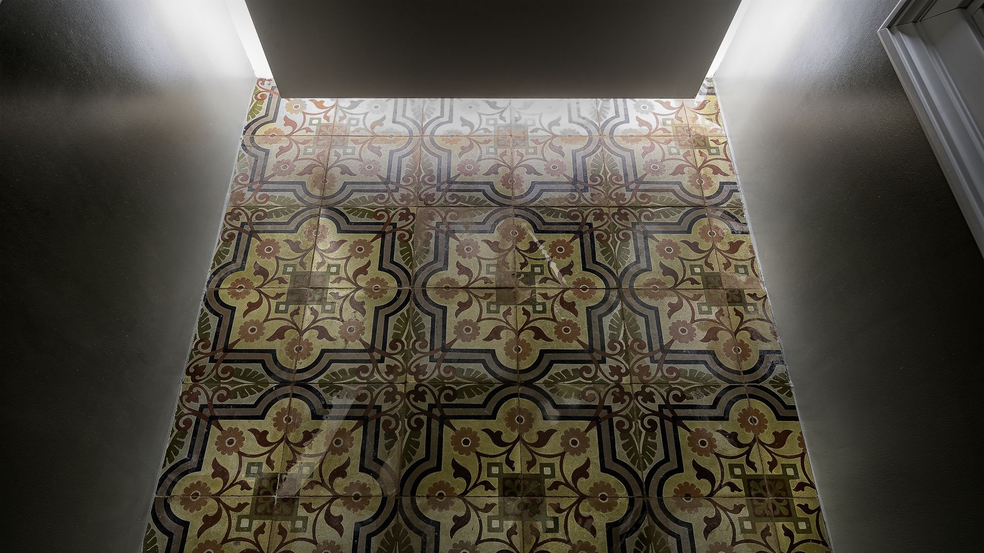 A tiled wall with a geometric pattern.