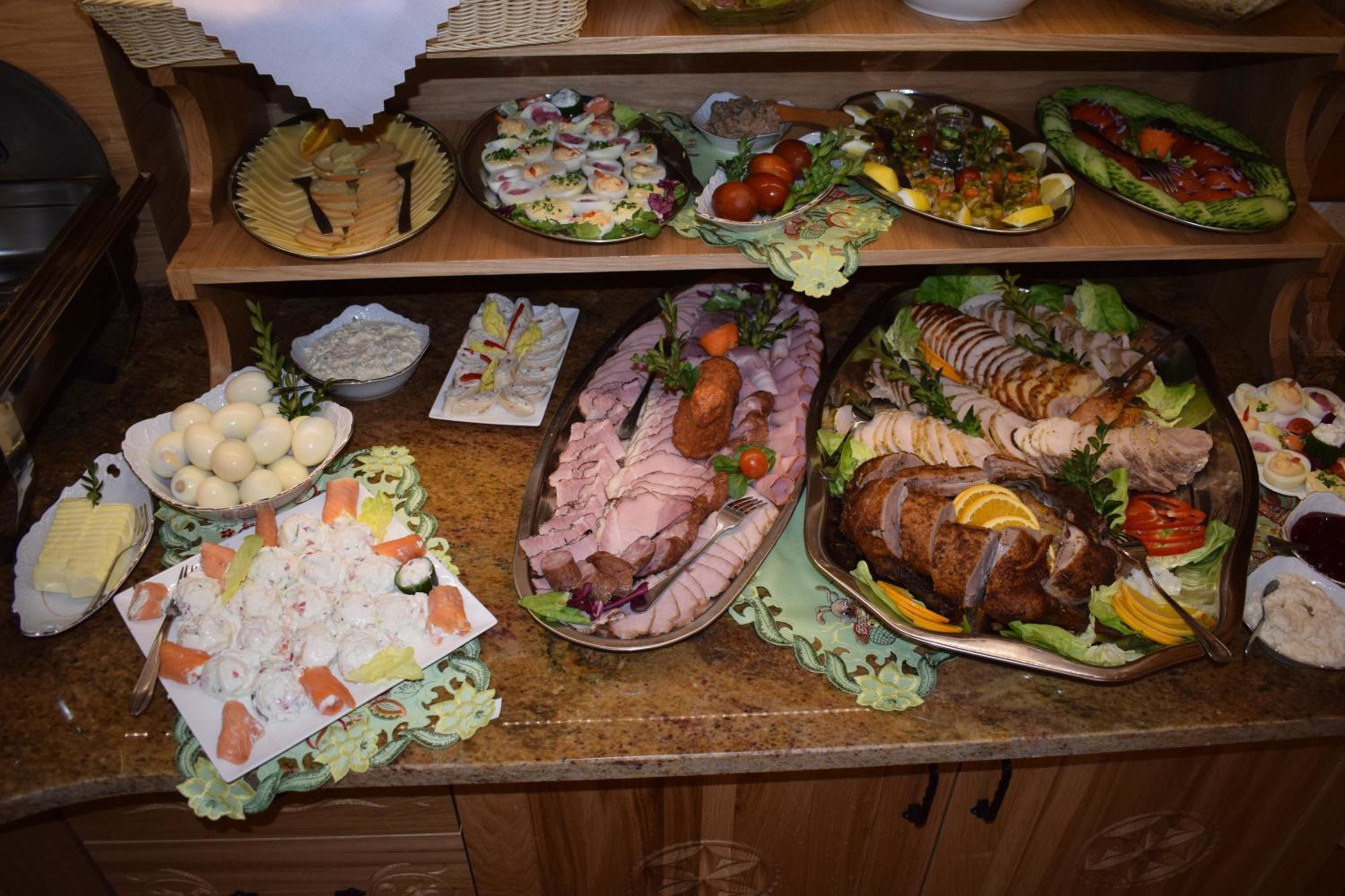 A buffet with various dishes including meats, salads, and appetizers.