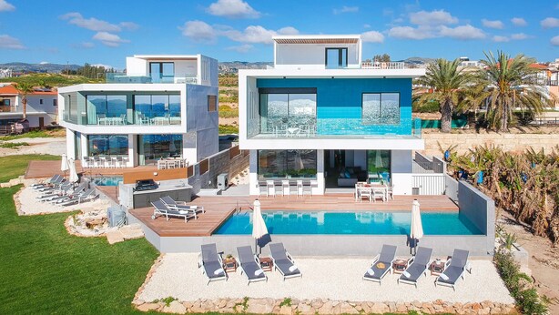 A modern two-story house with a pool, outdoor seating, and a view of the sea. - Villa Lara (Kouklia)