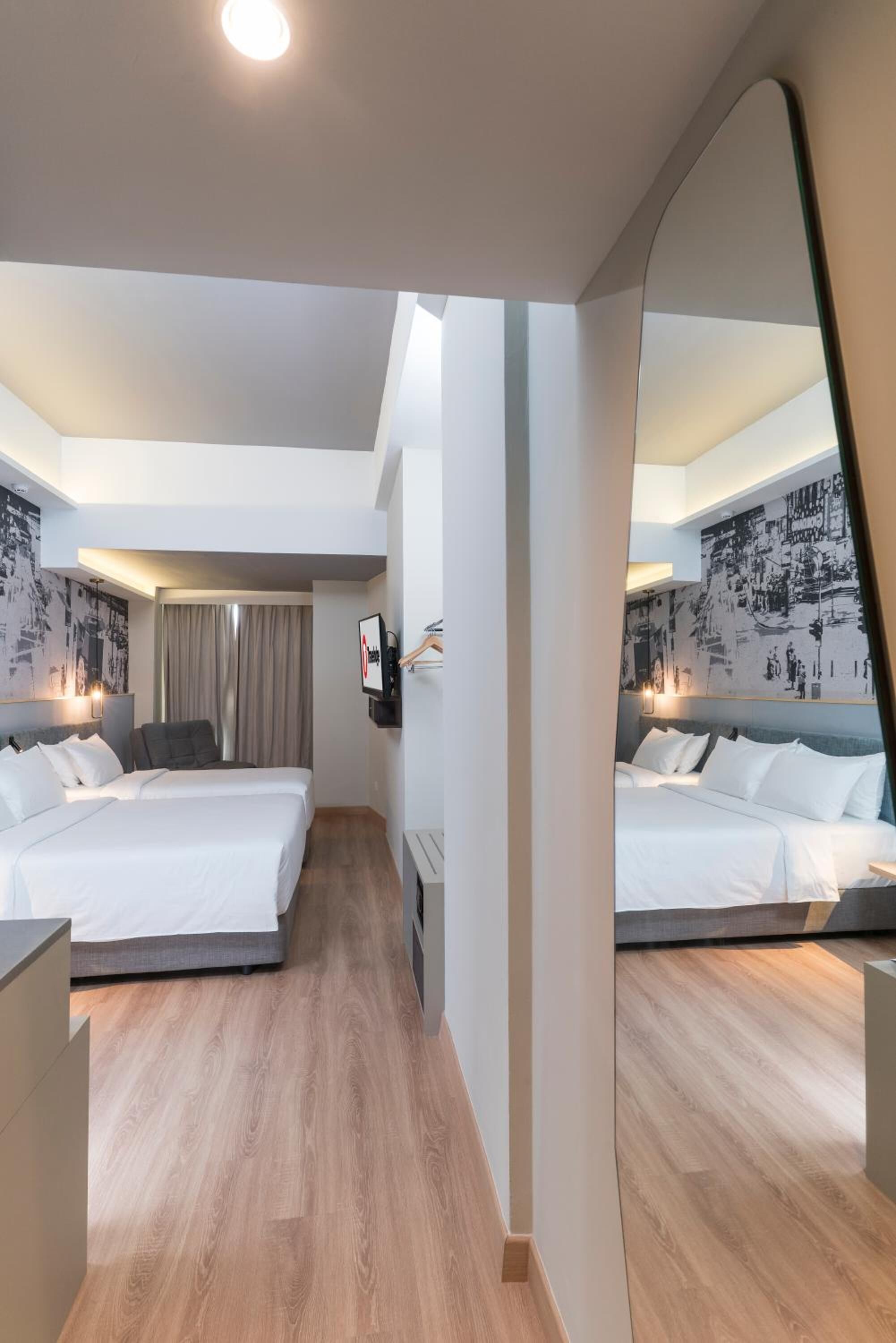 deluxe quadruple room, 2 queen beds | in-room safe, desk, laptop workspace, soundproofing