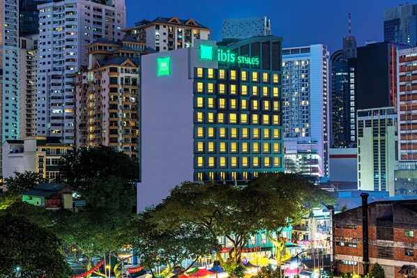 A high-rise hotel with a prominent green "ibis styles" sign, multiple floors, and a modern architectural design. - Ibis Styles Kuala Lumpur Bukit Bintang (Kuala Lumpur)