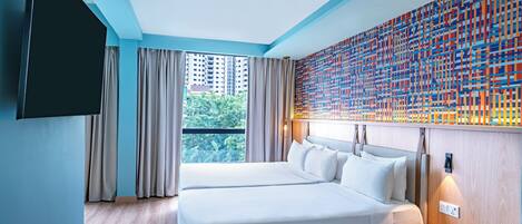 A modern hotel room with a large bed, a TV, and a view of the city.