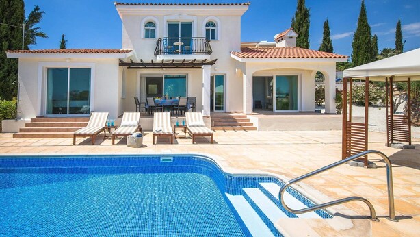 A modern villa with a swimming pool, outdoor seating, and a covered patio. - Villa Luna (Pegeia)