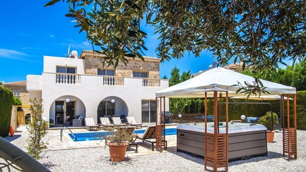 A two-story building with a pool, outdoor seating, and a hot tub. - Villa Maria (Pegeia)