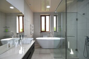 Suite, City View, Garden Area | Bathroom | Separate tub and shower, spring water tub, free toiletries, hair dryer