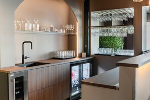 A modern kitchen with a built-in sink, wooden cabinets, and a refrigerator. - Best Western Hotel Alta (Alta)