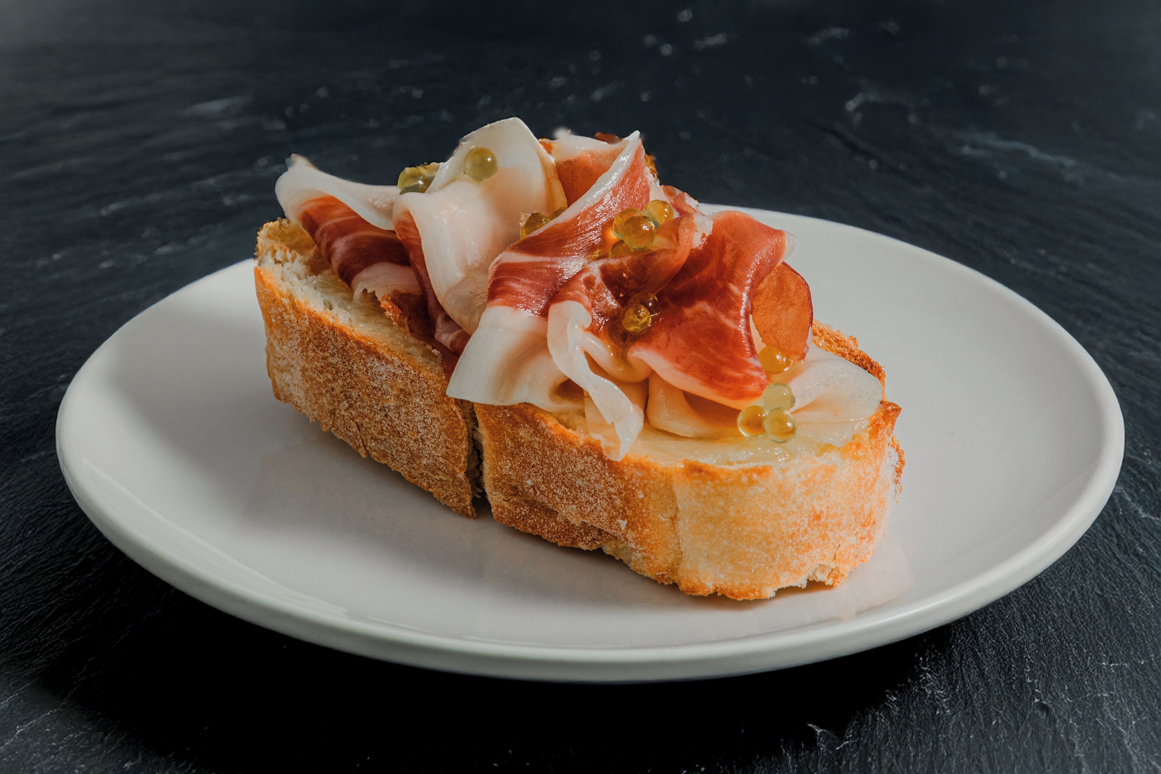 A sandwich on a white plate.