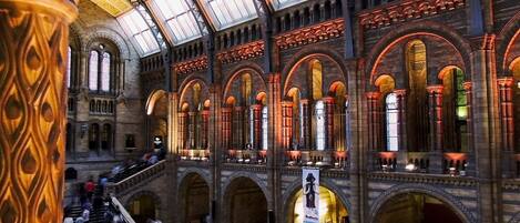 A spacious interior with high arched ceilings and multiple staircases.