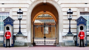 A grand entrance with a large arched doorway, flanked by two guards in red uniforms. - The New Kent Road Apartments (London)