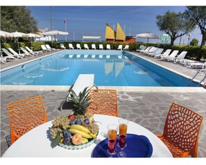 Seasonal outdoor pool, open 10:00 AM to 7:00 PM, pool umbrellas