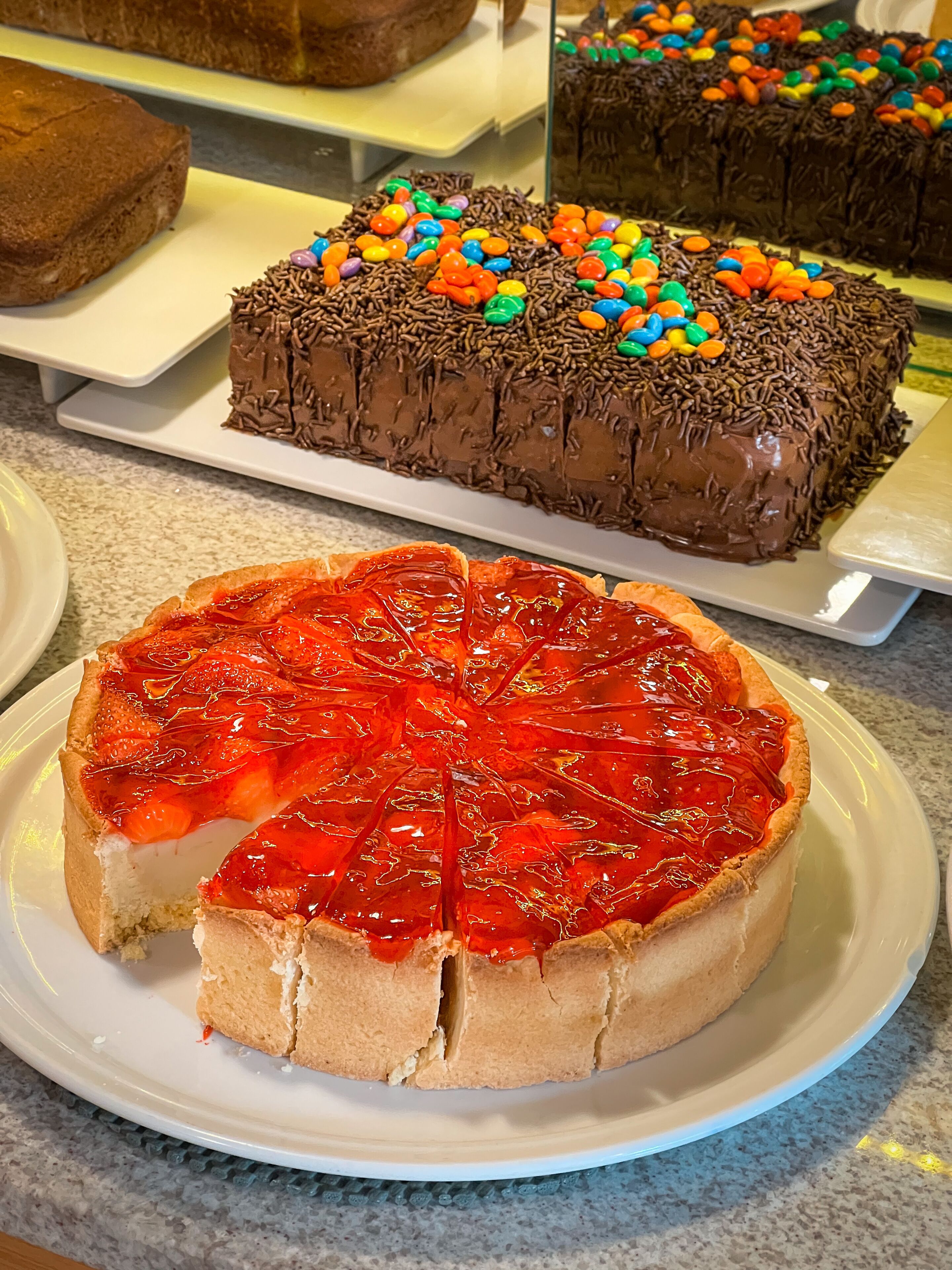 A display of cakes on a countertop.