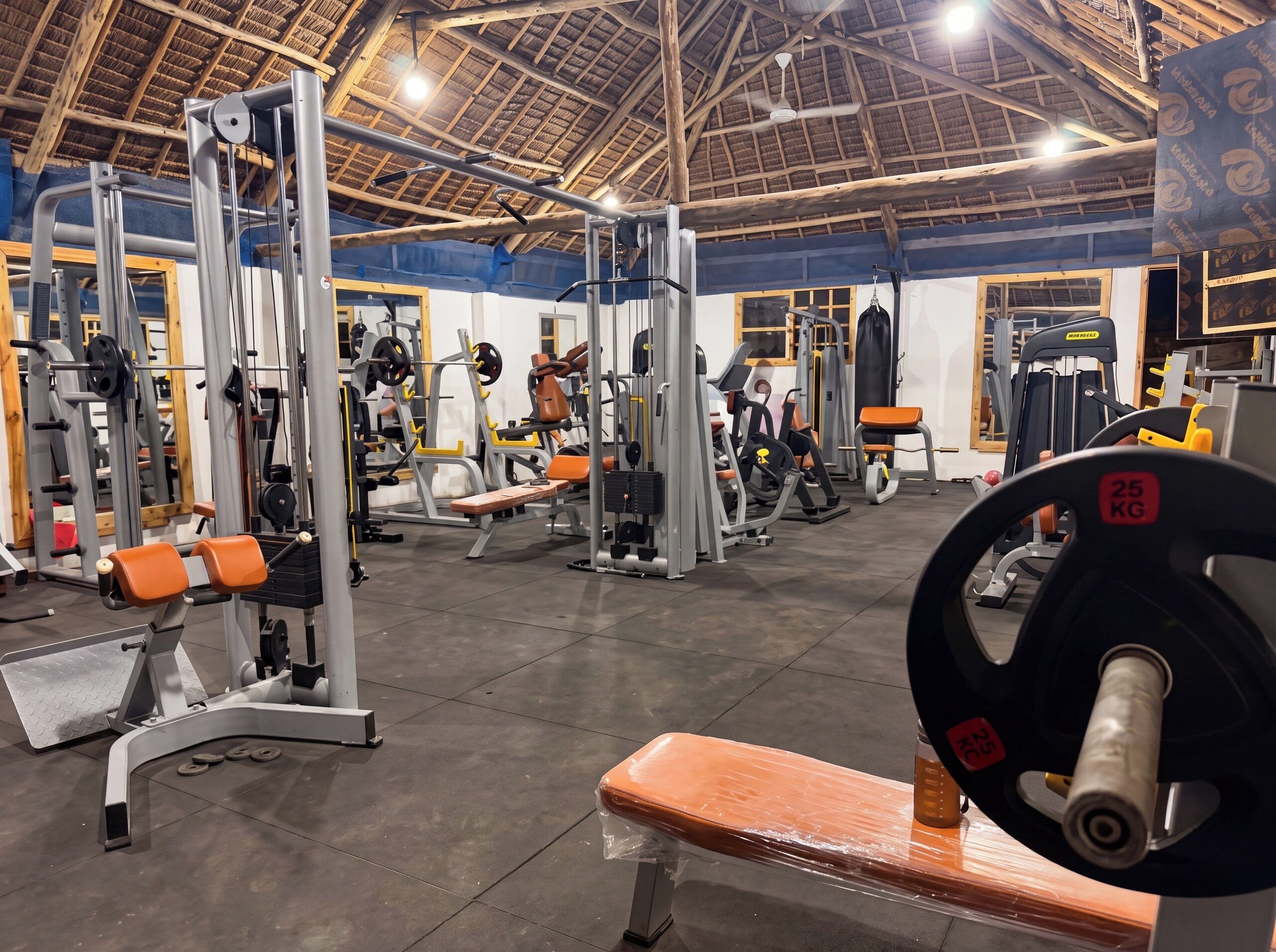 A gym with various exercise equipment, including weight machines and free weights.
