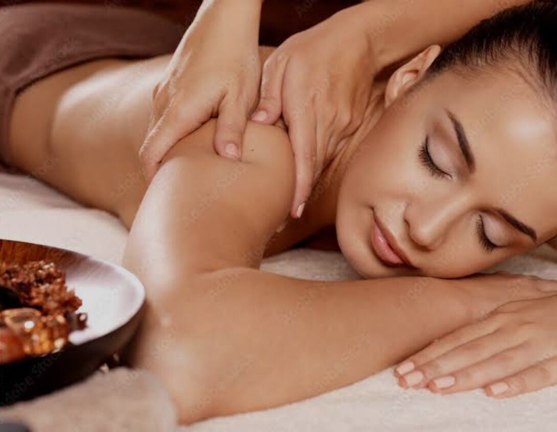 A person receiving a massage on a massage table.